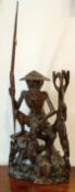 HEAVILY CARVED ORIENTAL FIGURE GROUP DEPICTING A FISHERMAN WITH FISH, APPROXIMATELY 56.5cm HIGH