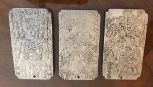 THREE SMALL ORIENTAL SILVER PLAQUES