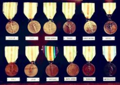 FRAMED COLLECTION OF TWELVE WWI VICTORY MEDALS WITH SOME SCARCE VARIANT INCLUDING SOUTH AFRICA AND