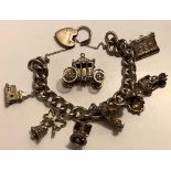 CHARM BRACELET WITH STERLING SILVER HEART LOCK, WITH EIGHT UNMARKED CHARMS INCLUDING CINDERELLA