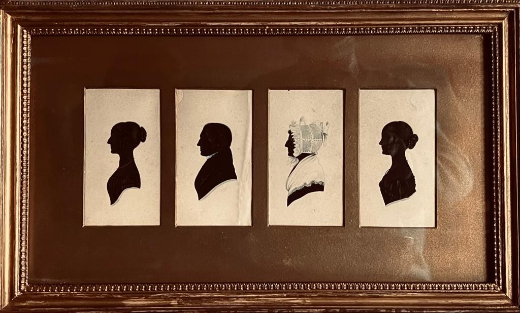 FRAMED FOUR SILHOUETTES OF AN UNKNOWN VICTORIAN FAMILY, FRAME SIZE APPROXIMATELY 30 x 47cm