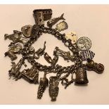 CHARM BRACELET WITH STERLING SILVER HEART LOCK, WITH SEVENTEEN UNMARKED CHARMS AND TWO CHARMS MARKED