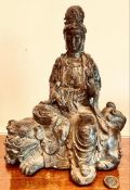 BRONZE PATINATED FIGURE DEPICTING KWAN YIN SEATED, APPROXIMATELY 29cm HIGH