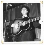 Two fan photographs of John Lennon playing live. These items are formerly the property of Beatles