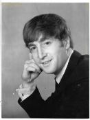 A collection of five original photographs of John Lennon some marked on reverse Robert Freeman.The