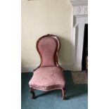 A 19th century carved mahogany nursing chair.