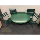 A folding metal garden table and four folding wood and metal chairs.