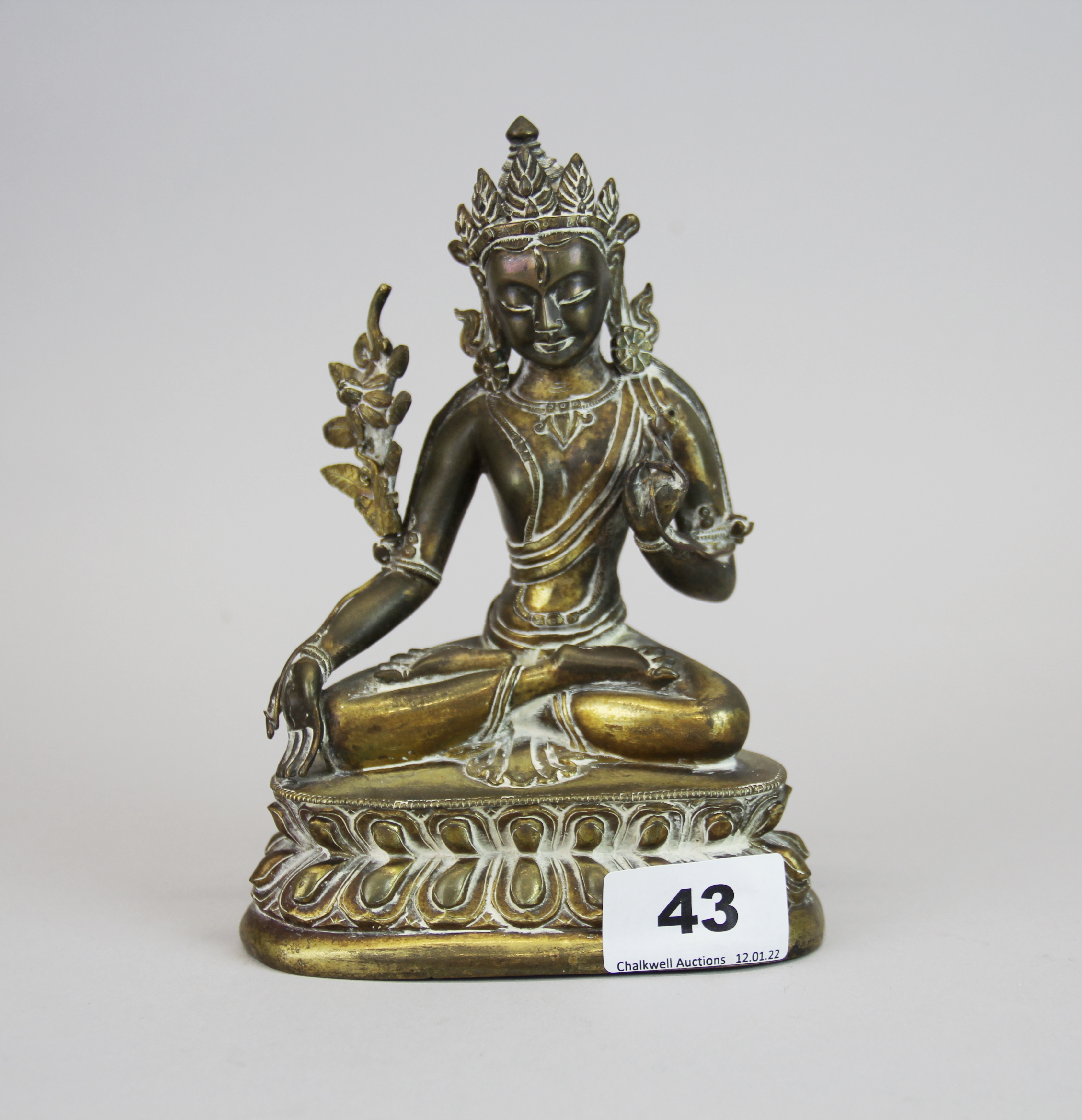 A 19th/ early 20th century Tibetan bronze figure of a seated Tara, H. 17cm.