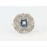 An Art Deco style 18ct white gold ring set with a centre aquamarine surrounded by two rows of