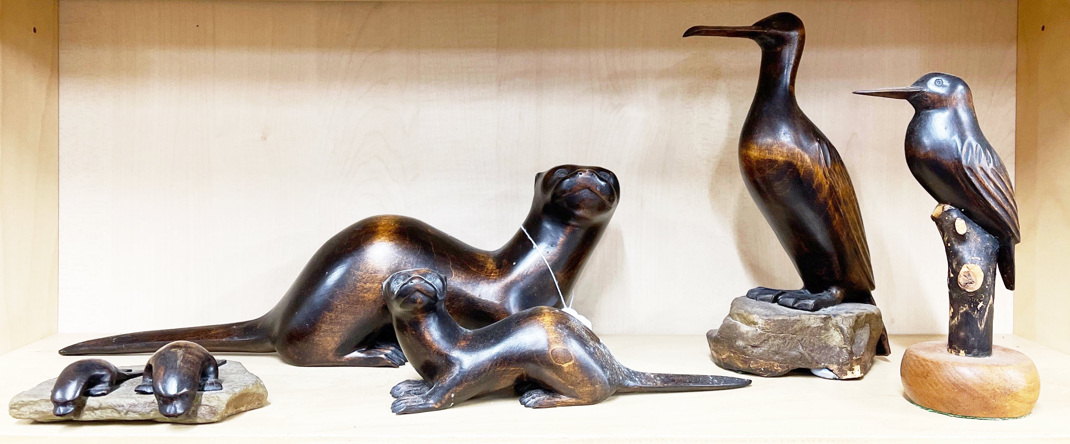 A group of Stuart Rogers, Appledore, signed Limewood figures of otters and birds, Longest L. 40cm.