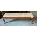A 1920's carved walnut footstool, L. 106cm.