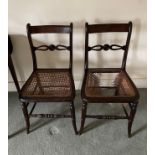 A pair of early 19th century cane seated chairs.