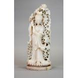 A large 19th/ early 20th century Chinese carved pink soapstone figure of a woman surrounded by