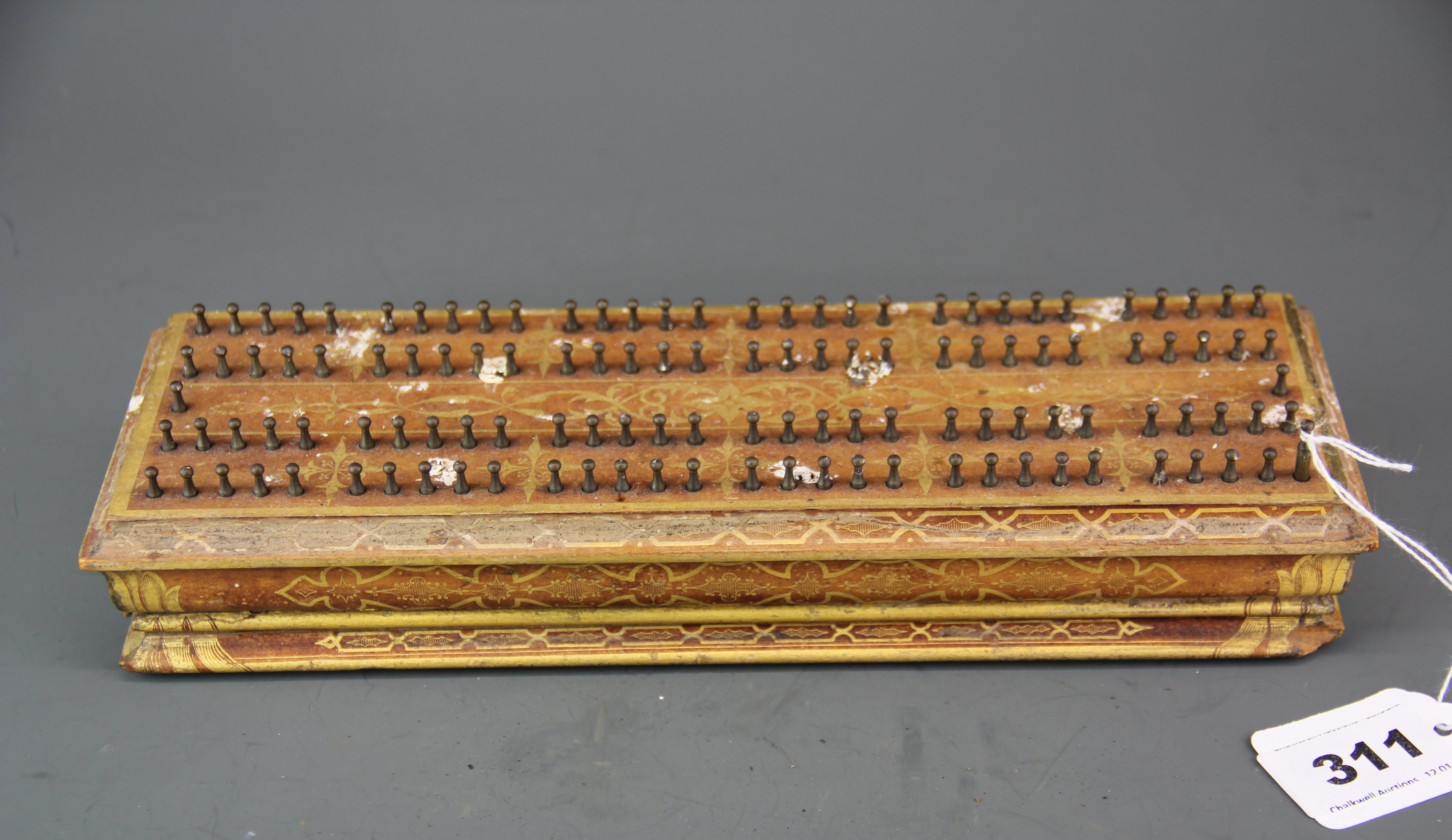 An unusual 19th century fixed peg cribbage score board by H. Brooks & Co, 28 x 9 x 5cm.