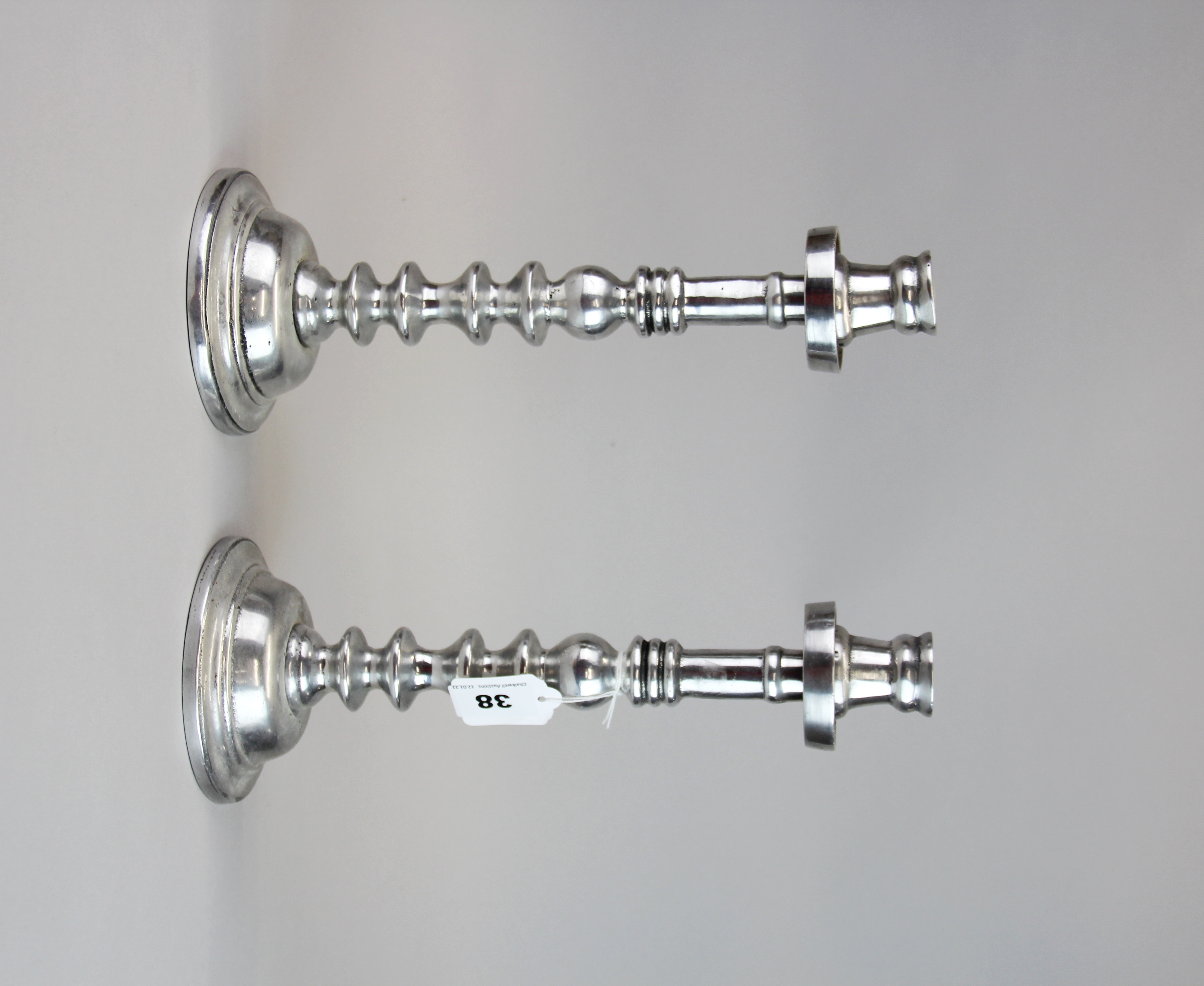 An interesting pair of mid 20th century aluminium candlesticks, H. 32cm.