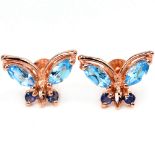 A pair of 925 silver rose gold gilt butterfly shaped earrings set with marquise cut blue topaz and