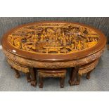 An Oriental carved hardwood coffee table with six nesting stools/ tables, largest 17 x 75 x 20cm.