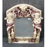 A reconstituted stone cherub garden mirror, H. 86cm.