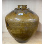 A large early Chinese glazed pottery storage jar, H. 39cm.