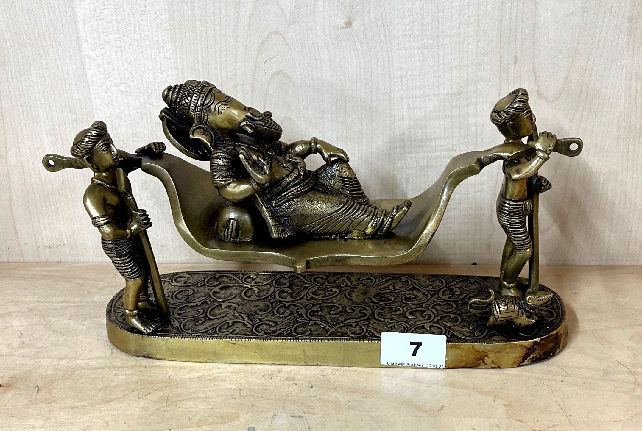 An unusual bronze/brass figure of the elephant god Ganesh being carried on a litter, 32 x 16cm.