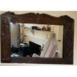 An early carved oak framed mirror, 86 x 65cm.