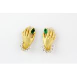 A pair of 18ct yellow gold hand shaped stud earrings each set with a marquise cut emerald and
