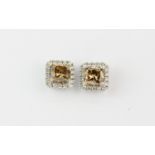 A pair of 18ct white gold cluster stud earrings each set with a princess cut champagne diamond,