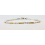 An 18ct white old bracelet set with 2.16ct brilliant cut diamonds and 2.25ct of yellow sapphires,