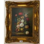 A gilt framed reproduction oil on board of a still life, frame size 45 x 56cm.