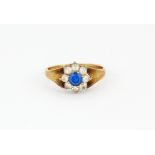 A hallmarked 9ct gold ring set with blue topaz and white stones, (N).