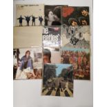 Ten Beatles LP records.