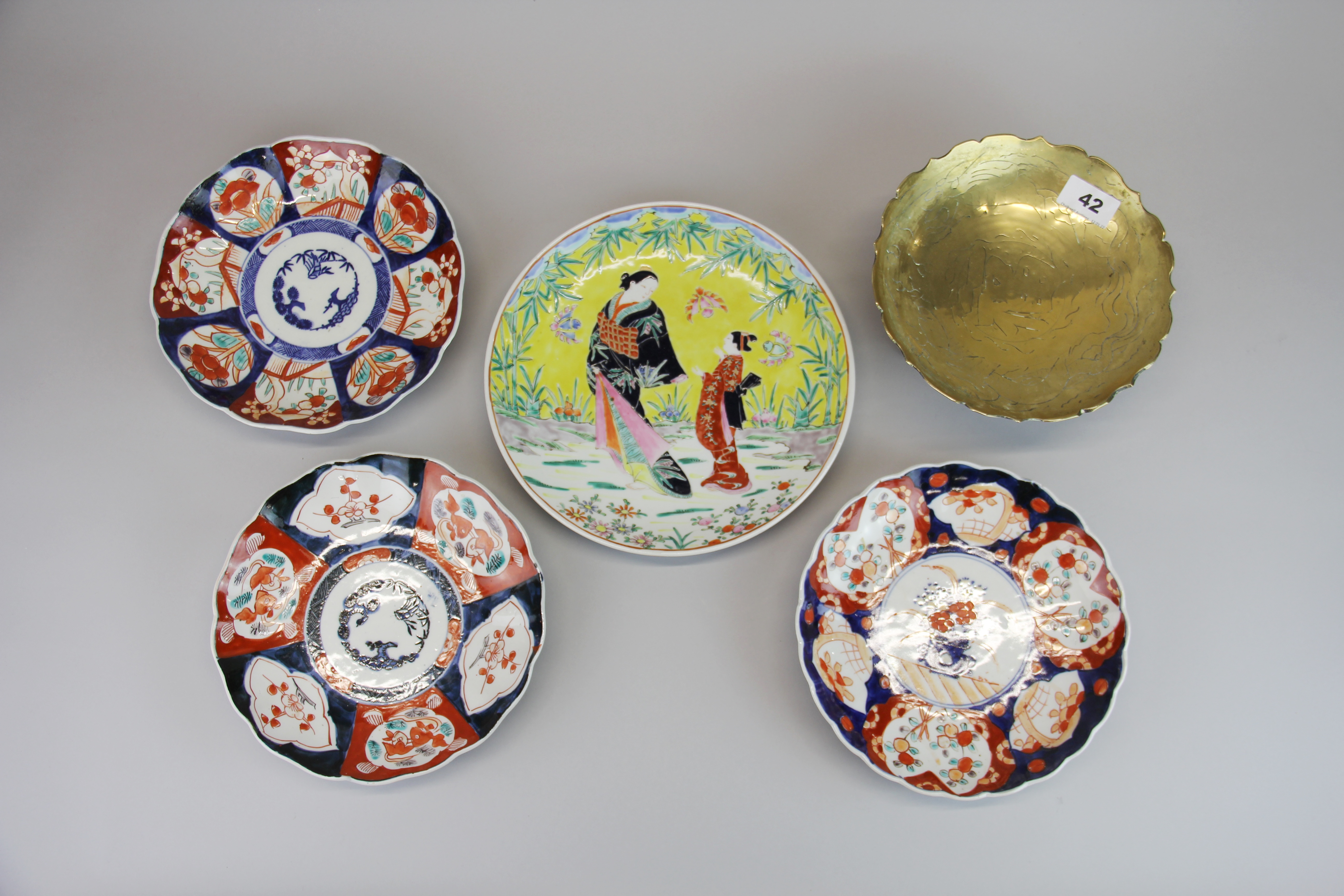 Three Japanese Imari plates, Dia. 22cm. Together with a Japanese hand enamelled plate, an engraved