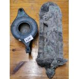 A bronze oil lamp and a terracotta wall figure, wall figure H. 39cm.