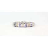 A 9ct white gold tanzanite and diamond set ring, (M.5).