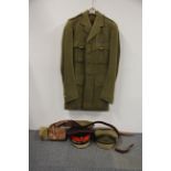 A vintage army uniform with two officers caps and belts.
