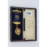 A 9ct gold Royal Antediluvian Order of Buffaloes medal c.1922 on a gilt metal and enamel ribbon.