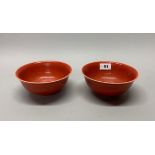 An interesting pair of Chinese orange/red glazed porcelain rice bowls, Dia. 16cm.