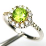 A 925 cluster ring set with peridot and white stones, (P).