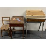 An antique pine lap desk hinged on to a metal base together with a further child's desk.