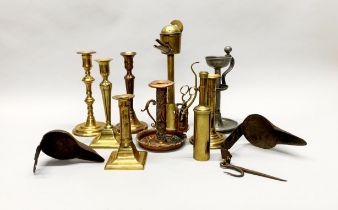 A group of mixed brass, pewter, copper and iron candlesticks, lamps and spout lamps etc tallest H.