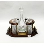 A presentation mahogany and brass tantalus stand with cut glass decanter and six glasses, W. 38cm.