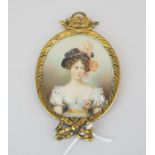 A gilt framed 19th century hand painted portrait miniature of a young woman, H. 9.5cm.