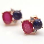 A pair of 925 silver rose gold gilt earrings set with cabochon cut sapphire and oval cut rubies,