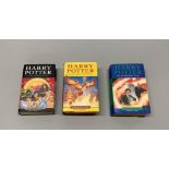 Three first edition Harry Potter books including a misprint Half Blood Prince stating 'eleven