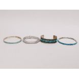 A group of mixed silver and white metal bracelets and bangles.