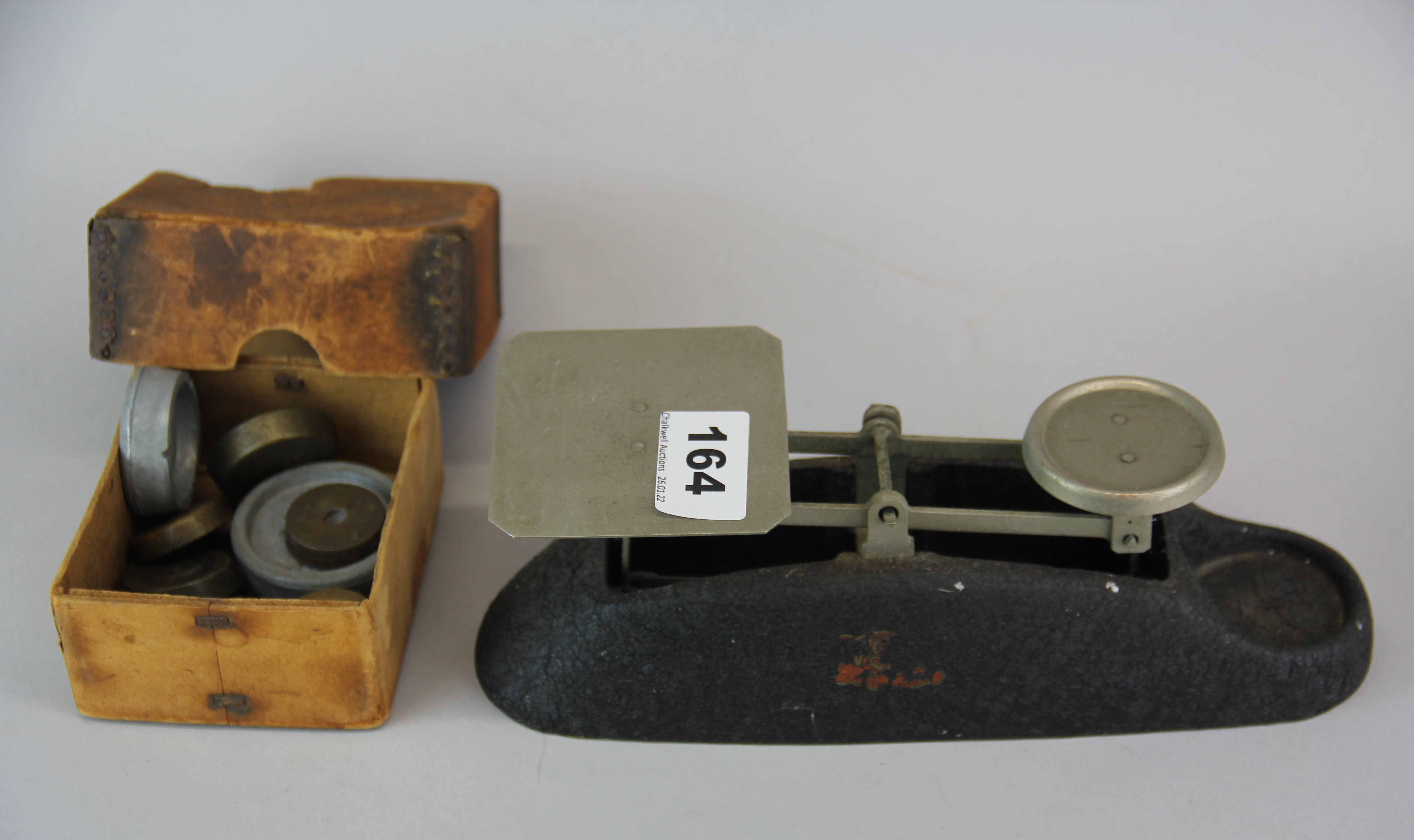 A vintage coin scale and weights.