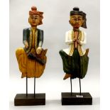 A pair of carved wooden oriental musician figures, H. 56cm.