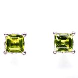 A pair of 925 silver stud earrings set with step cut peridots, L. 0.6cm.