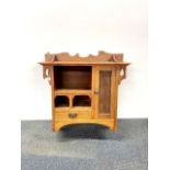 An Arts and Crafts carved oak wall cabinet, H. 68cm W. 68cm.