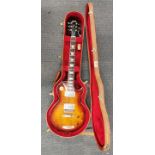 A cased Gibson standard Les Paul guitar.
